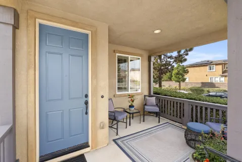 a balcony with wooden floor and outdoor seating