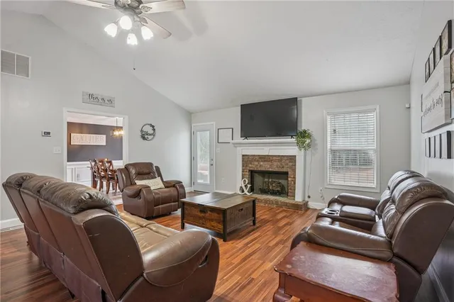 a living room with furniture a fireplace and a flat screen tv