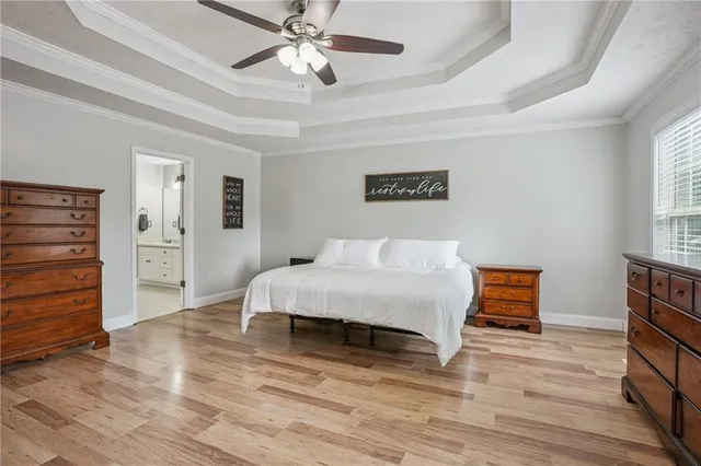 a spacious bedroom with a bed and a chandelier