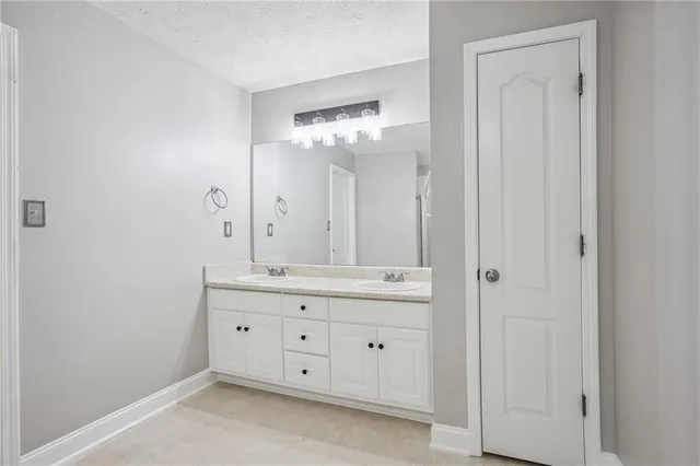 a bathroom with a double vanity sink and a mirror