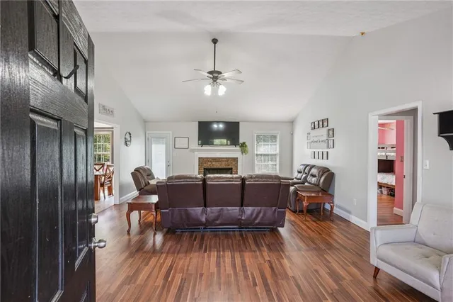 a living room with furniture fireplace and wooden floor