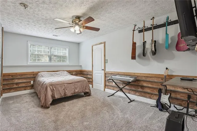 a bedroom with a bed a desk and chair