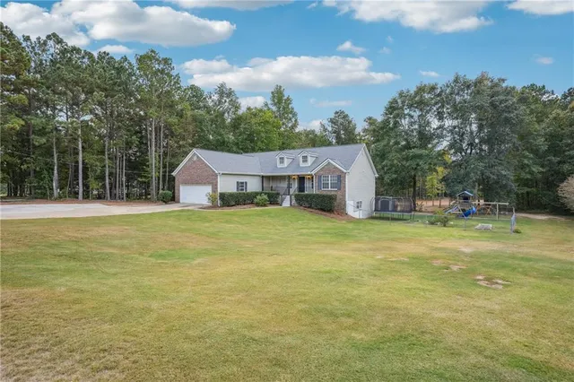 a house view with swimming pool in front of it