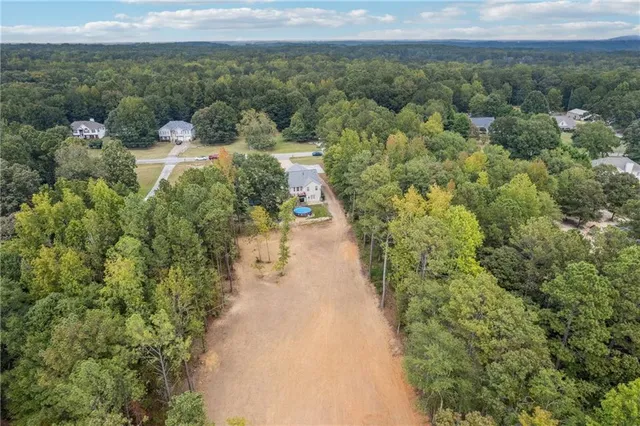 a view of a warehouse with a yard and mountain