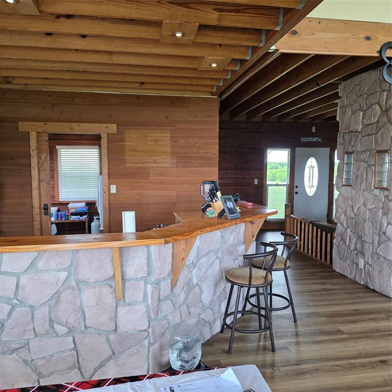 131 Hawk Ridge Decatur, TX 76234 - Photo 24 of 34 This interior features a stone-faced bar with a wooden countertop, complemented by a wood plank ceiling and walls