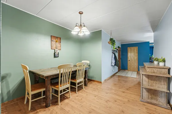 a view of a dining room with furniture and wooden floor