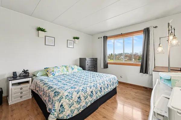 a bedroom with a large bed and a window