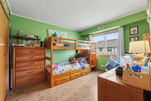 a bed room with furniture and a baby crib