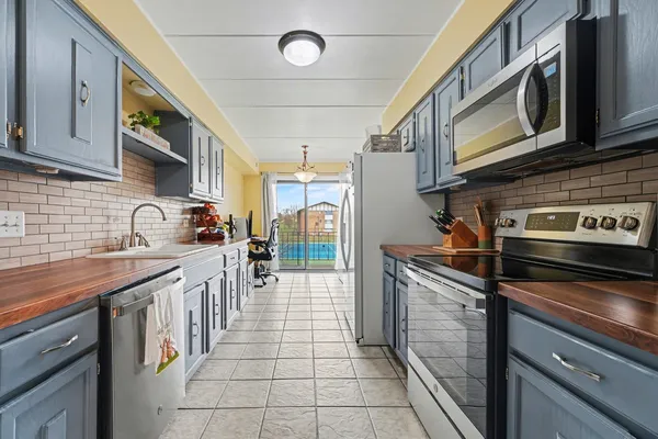 a kitchen with stainless steel appliances granite countertop a sink and cabinets