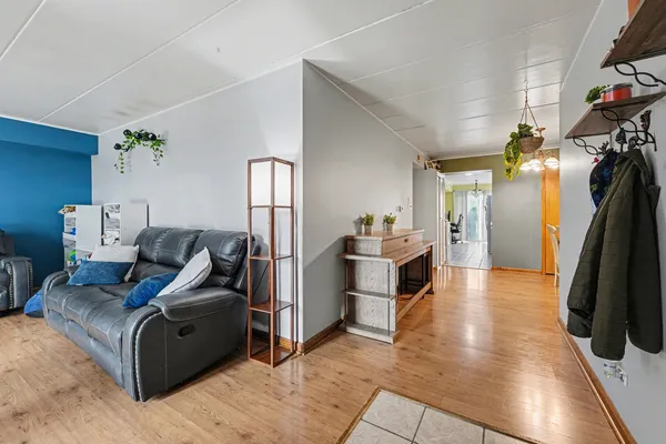 a living room with furniture and a walk in closet