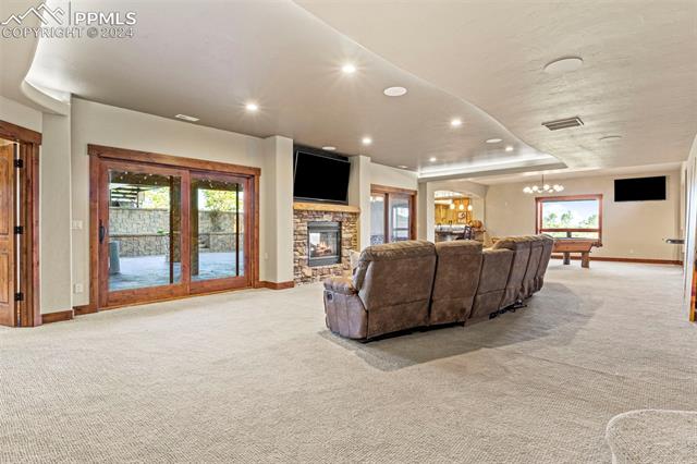 7115 Wildridge Road Colorado Springs, CO 80908 - Photo 38 of 49 Lower level living room with 2 walk outs