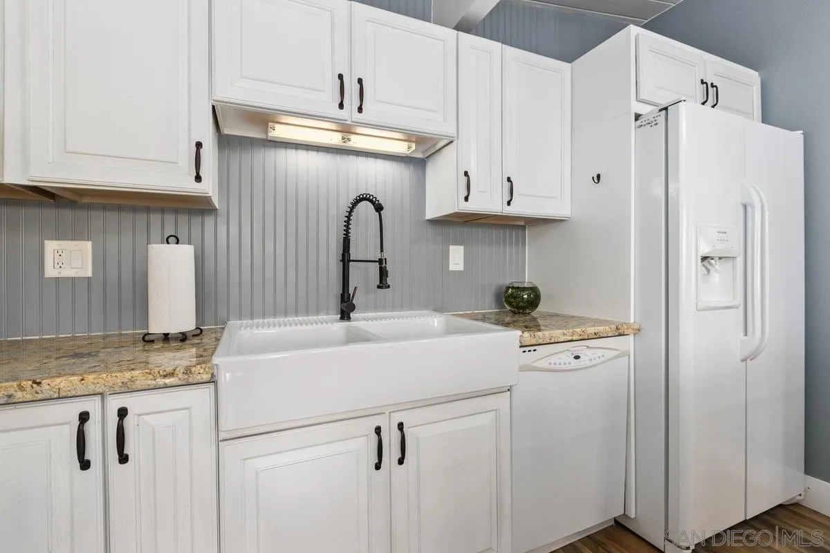 8605 Ellsworth Lane Santee, CA 92071 - Photo 11 of 26 a kitchen with stainless steel appliances granite countertop a sink a refrigerator a stove and white cabinets