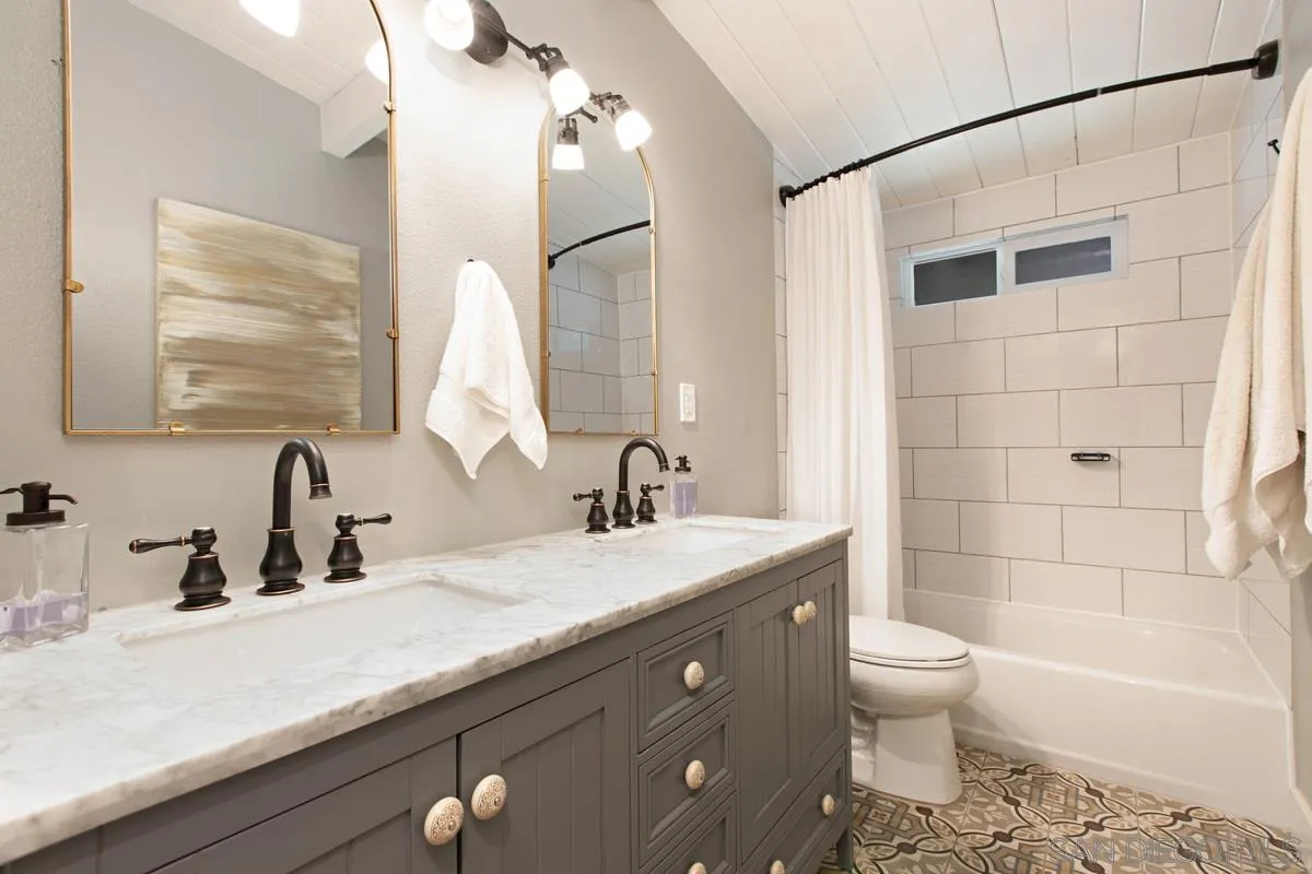 8605 Ellsworth Lane Santee, CA 92071 - Photo 15 of 26 a bathroom with a granite countertop sink a toilet and bathtub