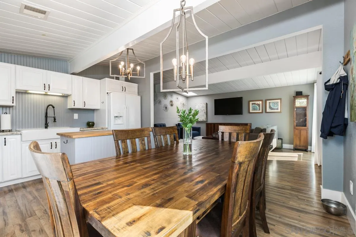 8605 Ellsworth Lane Santee, CA 92071 - Photo 7 of 26 a view of a dining room with furniture a rug and wooden floor