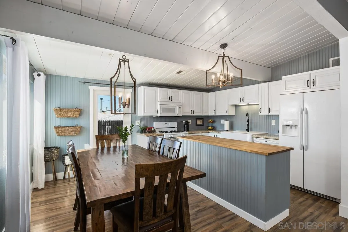 8605 Ellsworth Lane Santee, CA 92071 - Photo 8 of 26 a kitchen with stainless steel appliances a dining table chairs refrigerator and sink