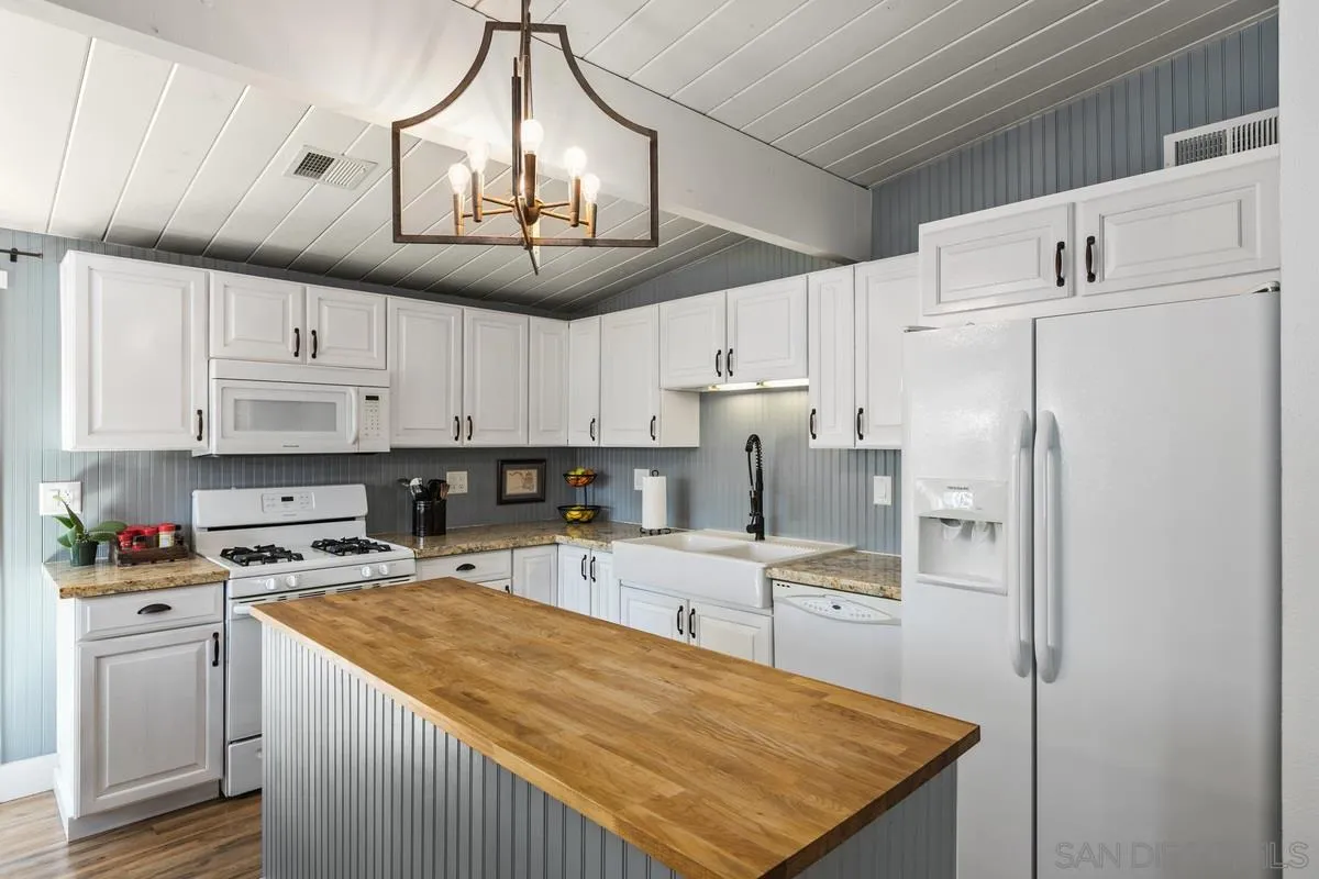 8605 Ellsworth Lane Santee, CA 92071 - Photo 9 of 26 a kitchen with cabinets and stainless steel appliances