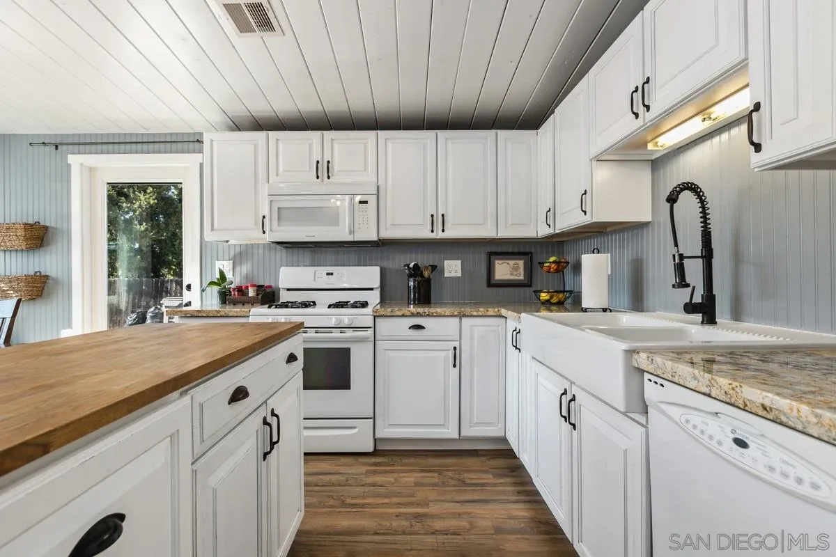 8605 Ellsworth Lane Santee, CA 92071 - Photo 10 of 26 a kitchen with granite countertop a sink stainless steel appliances and cabinets