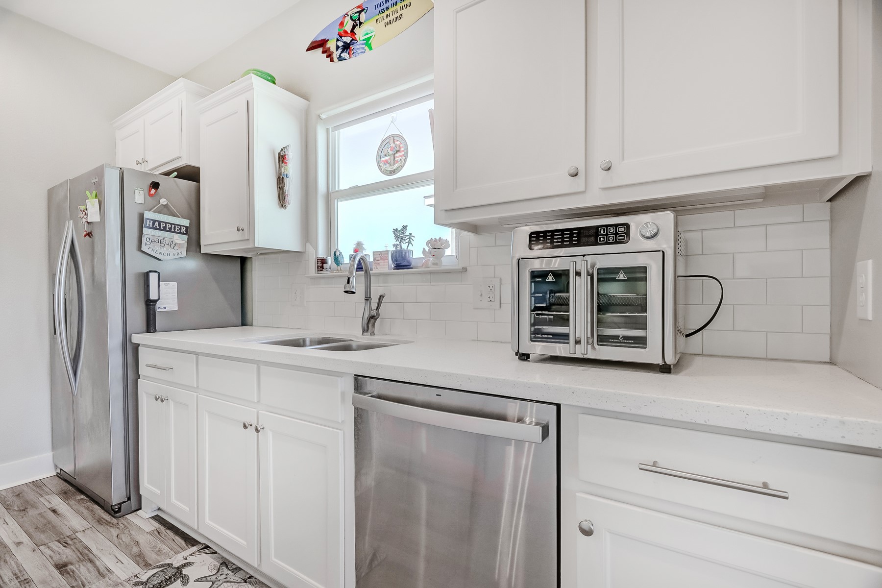 3292 Hidden Gold Crystal Beach Crystal Beach, TX 77650 - Photo 12 of 28 a kitchen with stainless steel appliances white cabinets and a sink