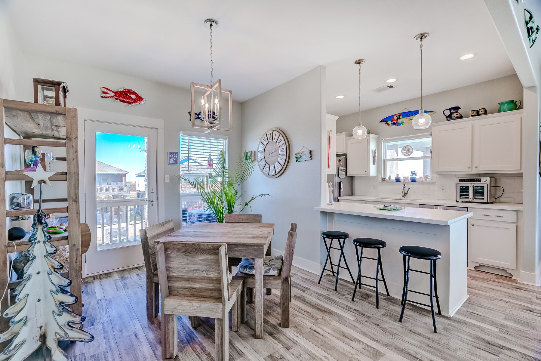 3292 Hidden Gold Crystal Beach Crystal Beach, TX 77650 - Photo 15 of 28 a kitchen with stainless steel appliances granite countertop a dining table chairs stove and cabinets