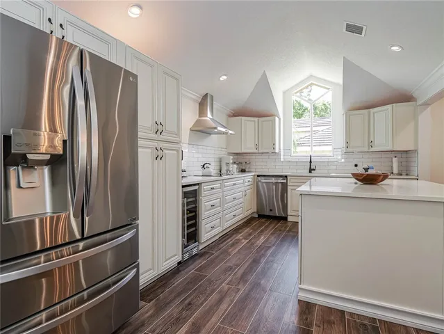 a kitchen with stainless steel appliances a refrigerator sink and microwave