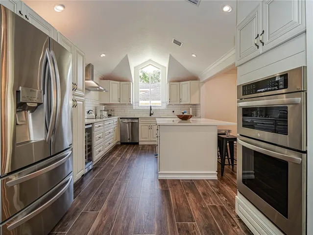 a kitchen with a sink stainless steel appliances and cabinets