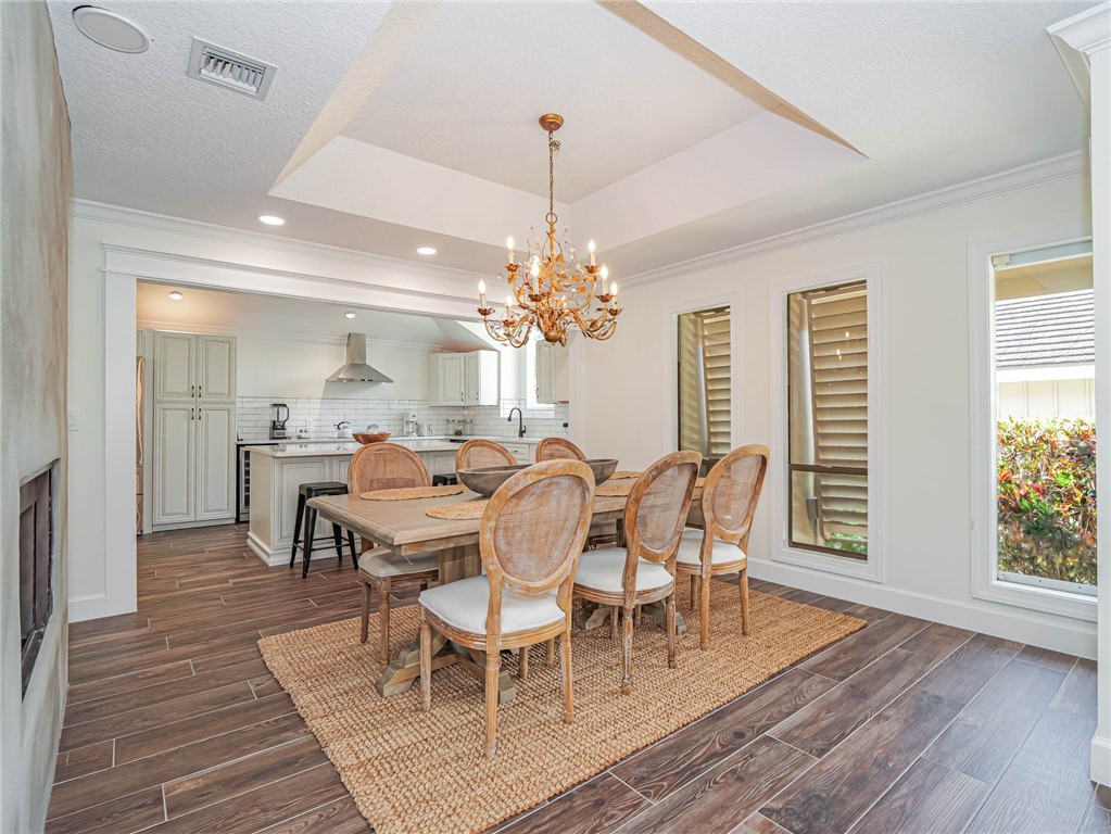 5101 Florida A1A, Unit 7 Vero Beach, FL 32963 - Photo 17 of 35 a view of a dining room with furniture window and wooden floor