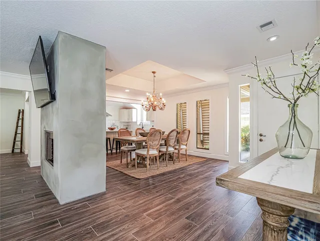 a dining room with furniture window and wooden floor