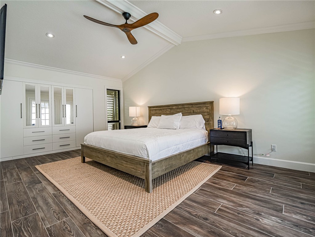 5101 Florida A1A, Unit 7 Vero Beach, FL 32963 - Photo 20 of 35 a bedroom with a bed lamp closet and windows