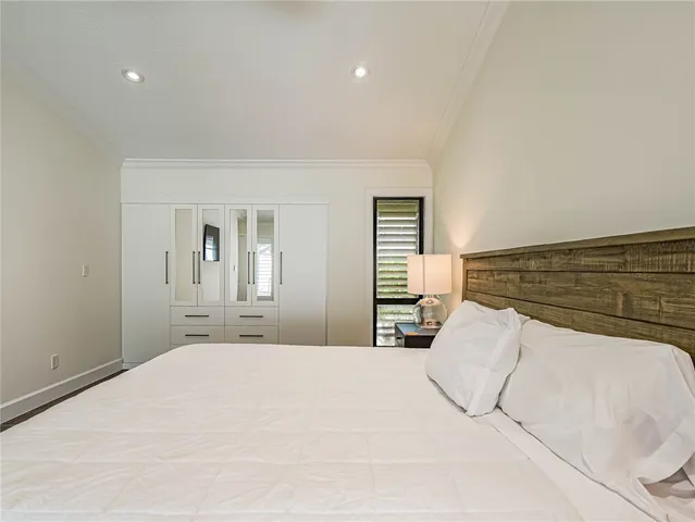 a bedroom with a bed and closet with mirror