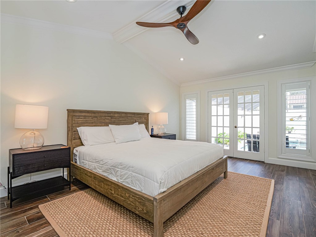 5101 Florida A1A, Unit 7 Vero Beach, FL 32963 - Photo 23 of 35 a bedroom with a large bed a lamp and a rug