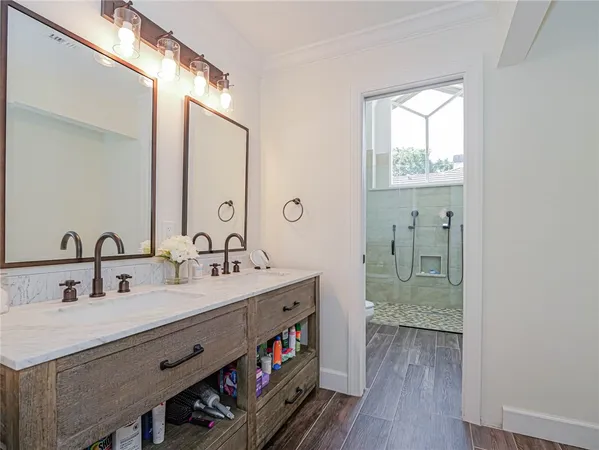 a bathroom with a double vanity sink and a mirror