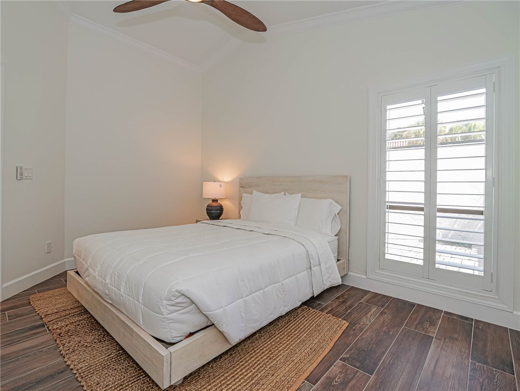 5101 Florida A1A, Unit 7 Vero Beach, FL 32963 - Photo 27 of 35 a bedroom with a bed and a window