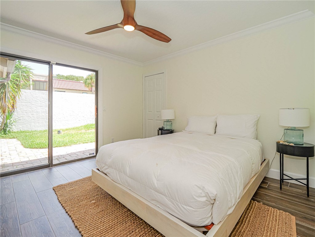 5101 Florida A1A, Unit 7 Vero Beach, FL 32963 - Photo 31 of 35 a bedroom with a large bed and a large window