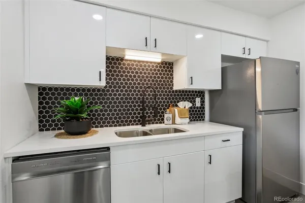a kitchen with a sink a stove and cabinets