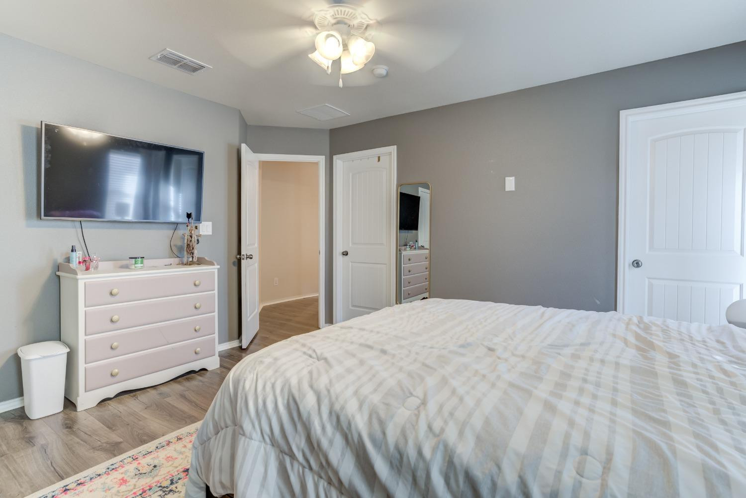 5725 110th Street Lubbock, TX 79424 - Photo 20 of 24 a bedroom with a bed and a flat screen tv