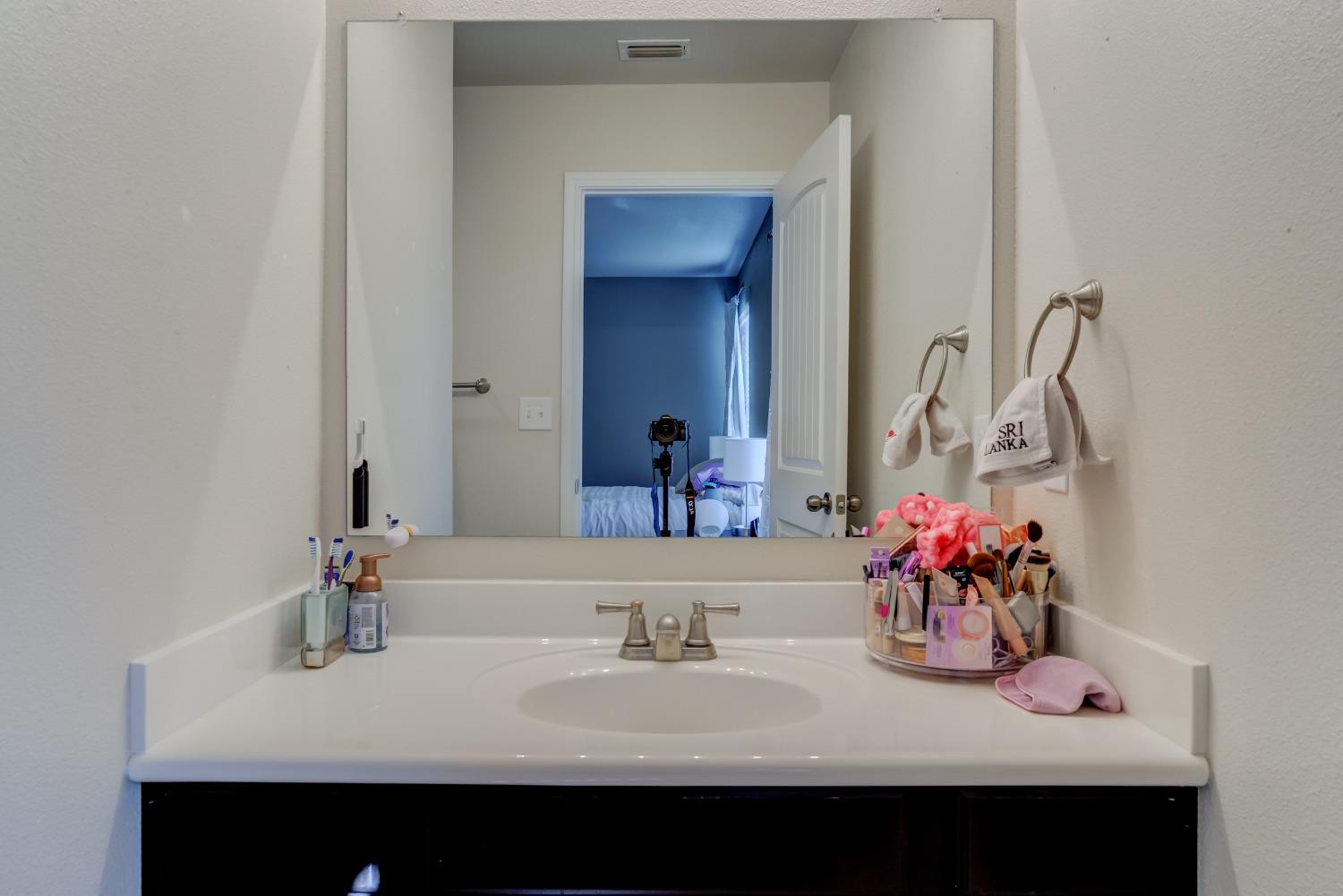 5725 110th Street Lubbock, TX 79424 - Photo 21 of 24 a bathroom with a sink and a mirror