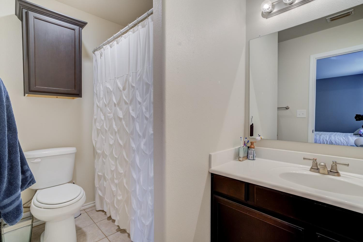 5725 110th Street Lubbock, TX 79424 - Photo 22 of 24 a bathroom with a sink a toilet and shower