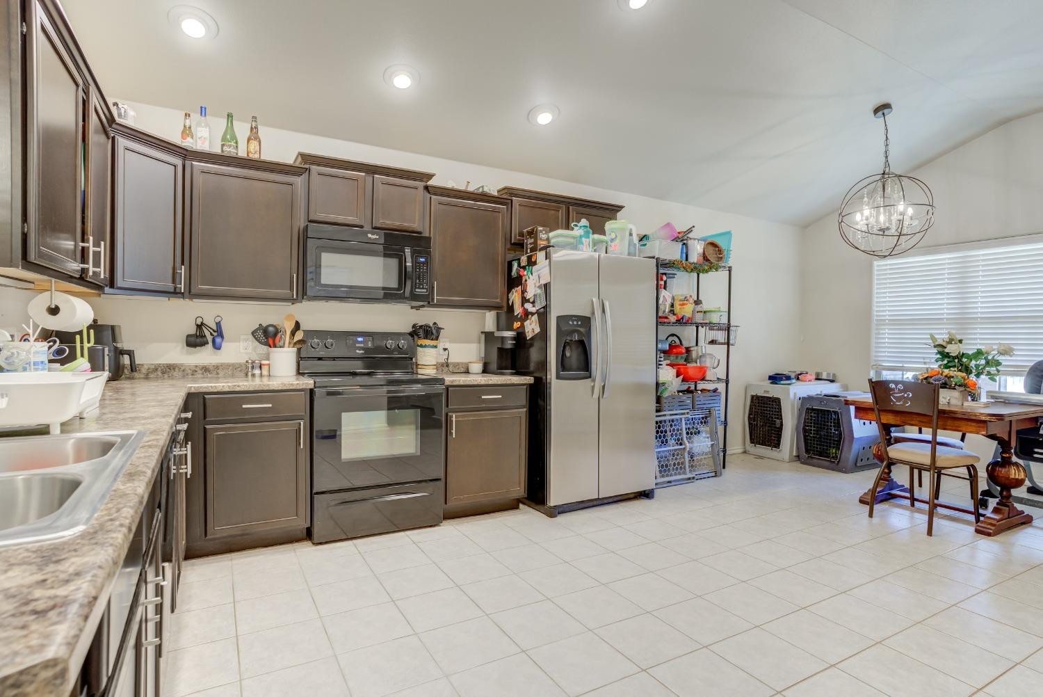 5725 110th Street Lubbock, TX 79424 - Photo 6 of 24 a kitchen with refrigerator cabinets and a sink
