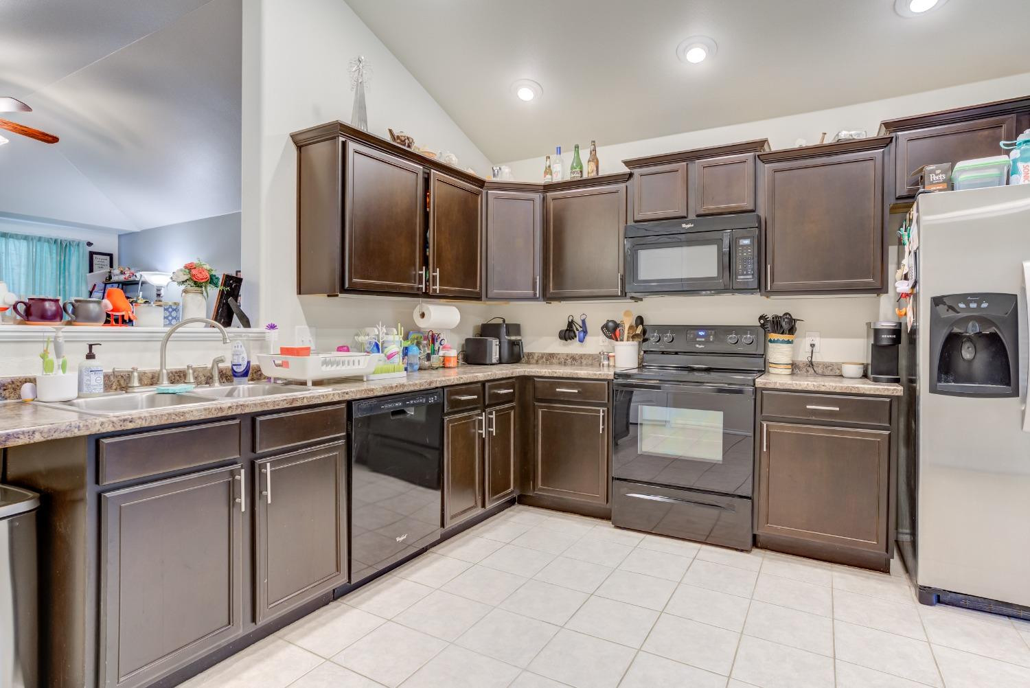 5725 110th Street Lubbock, TX 79424 - Photo 7 of 24 a kitchen with a sink stove and cabinets