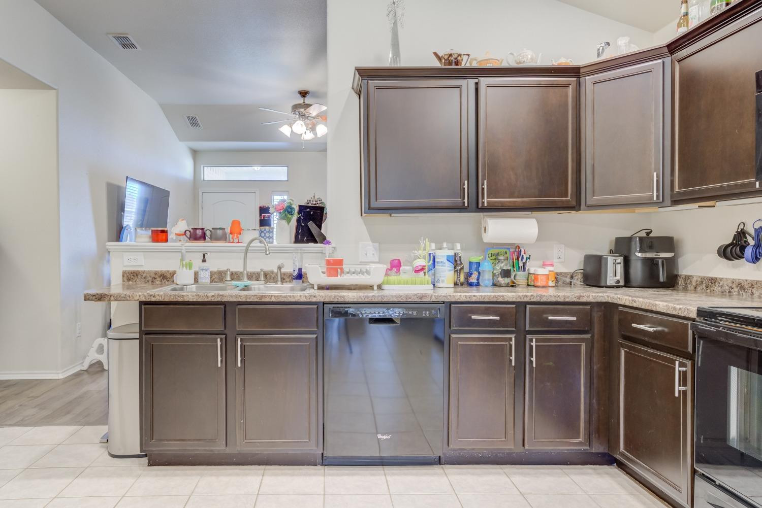 5725 110th Street Lubbock, TX 79424 - Photo 8 of 24 a kitchen with stainless steel appliances granite countertop a sink and cabinets