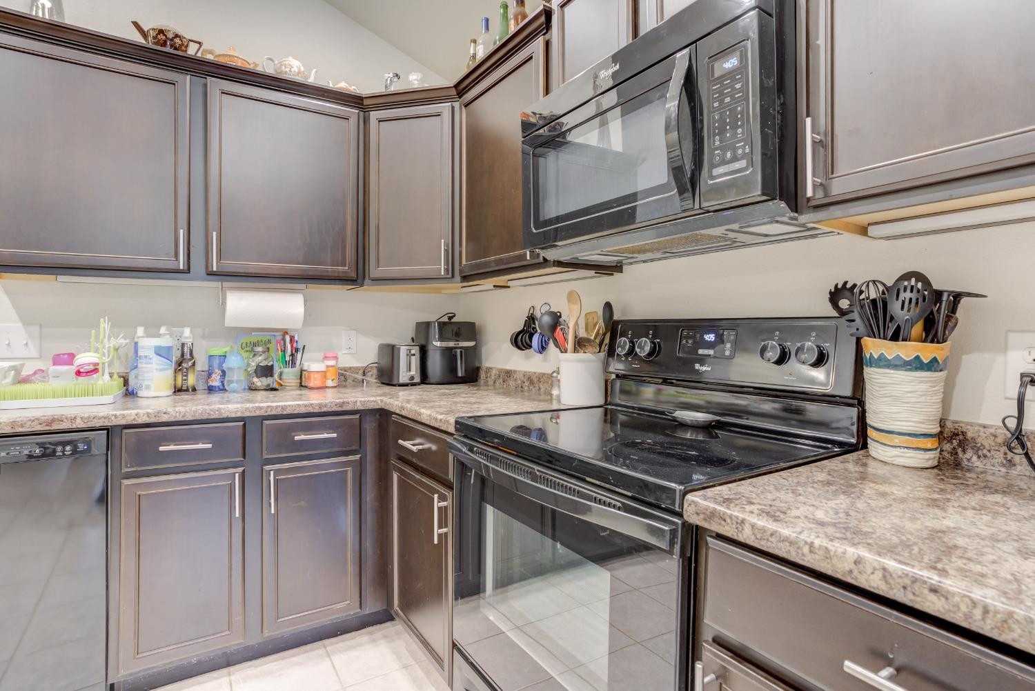 5725 110th Street Lubbock, TX 79424 - Photo 9 of 24 a kitchen with stainless steel appliances granite countertop a sink stove and cabinets