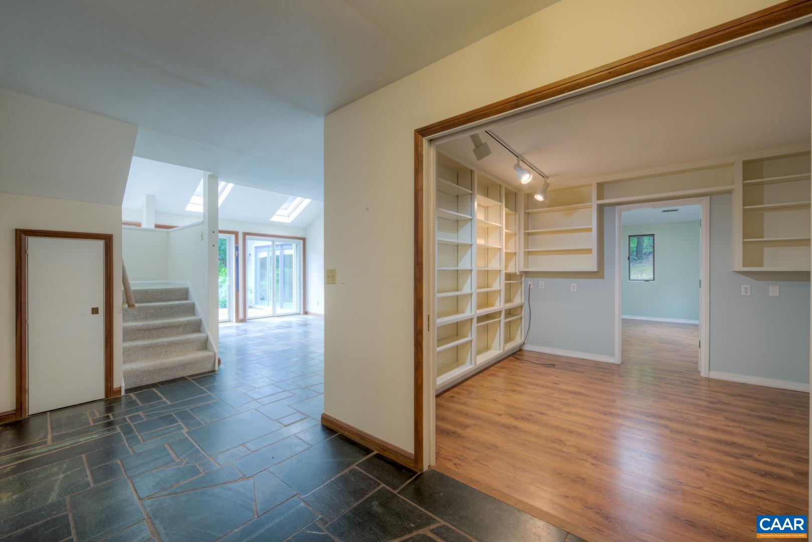 305 Cedar Bluff Road Charlottesville, VA 22901 - Photo 14 of 37 a view of a hallway with wooden floor and a living room