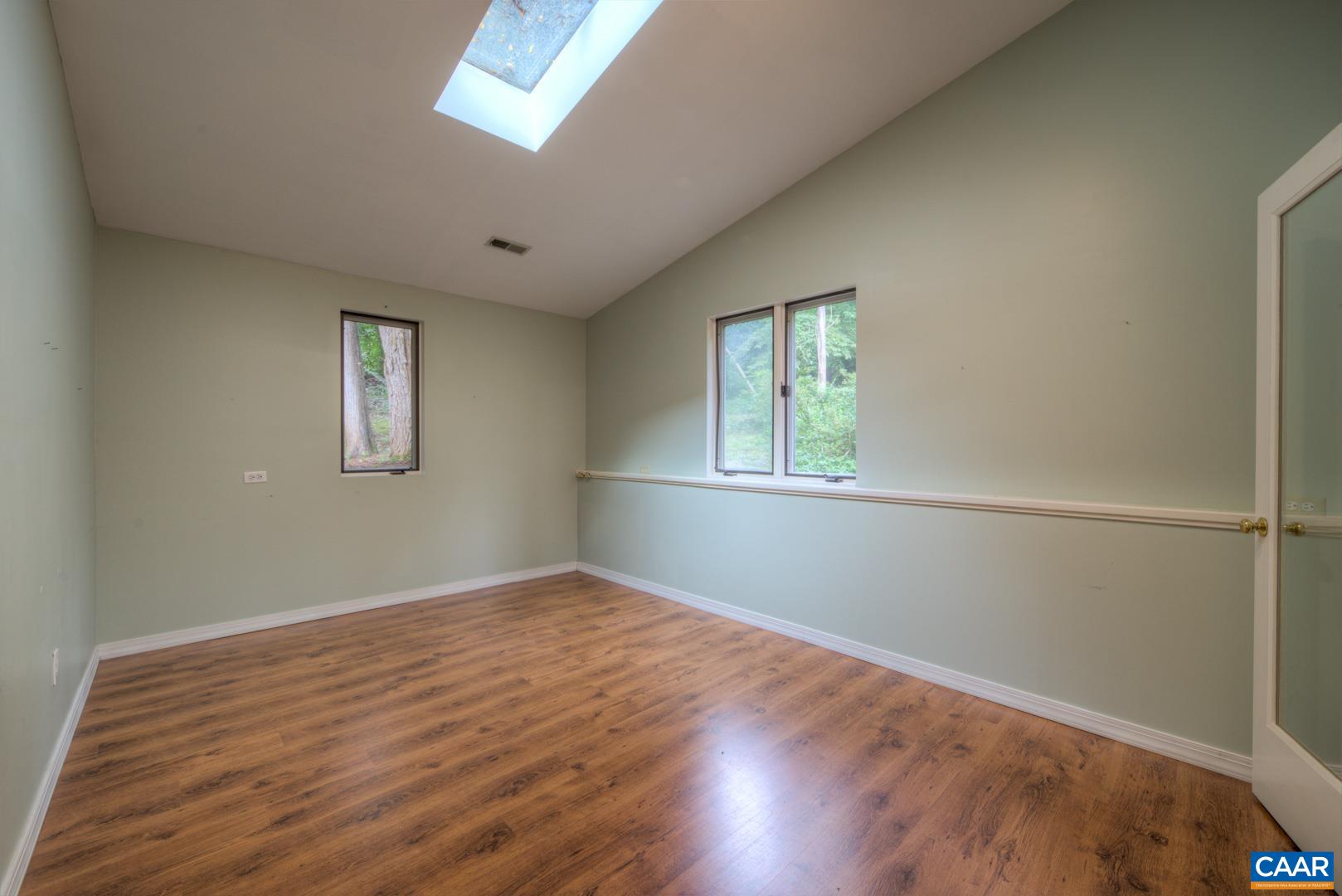305 Cedar Bluff Road Charlottesville, VA 22901 - Photo 18 of 37 an empty room with wooden floor and windows