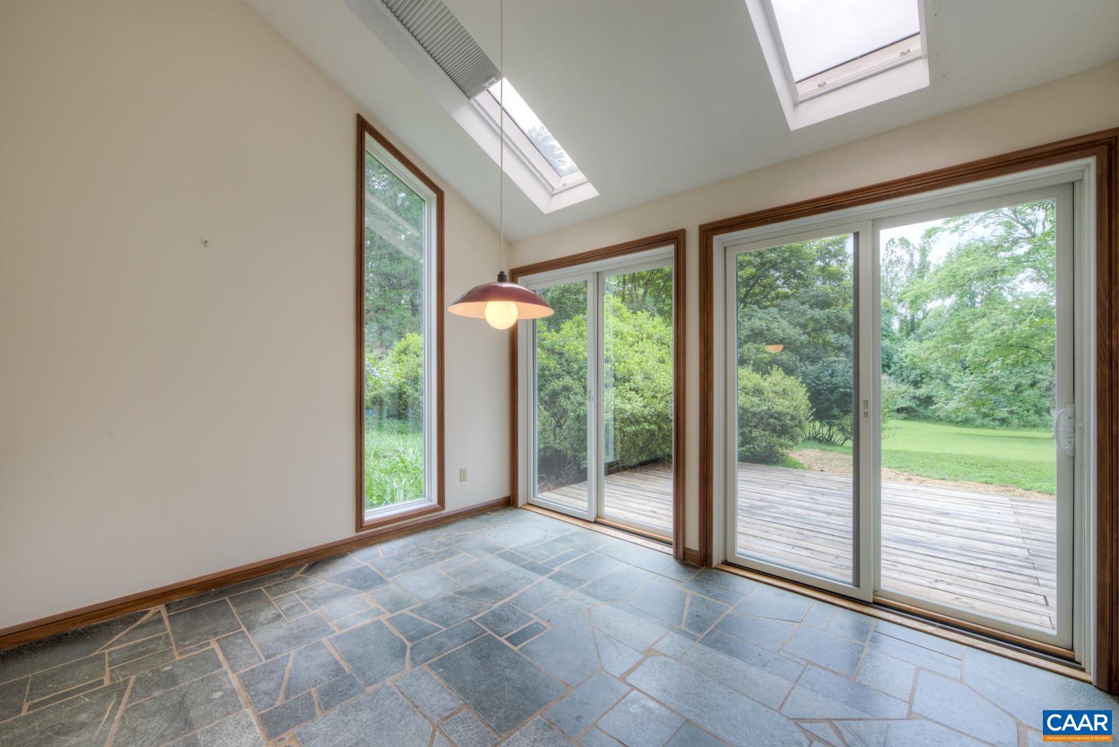 305 Cedar Bluff Road Charlottesville, VA 22901 - Photo 25 of 37 a view of an empty room with windows and balcony