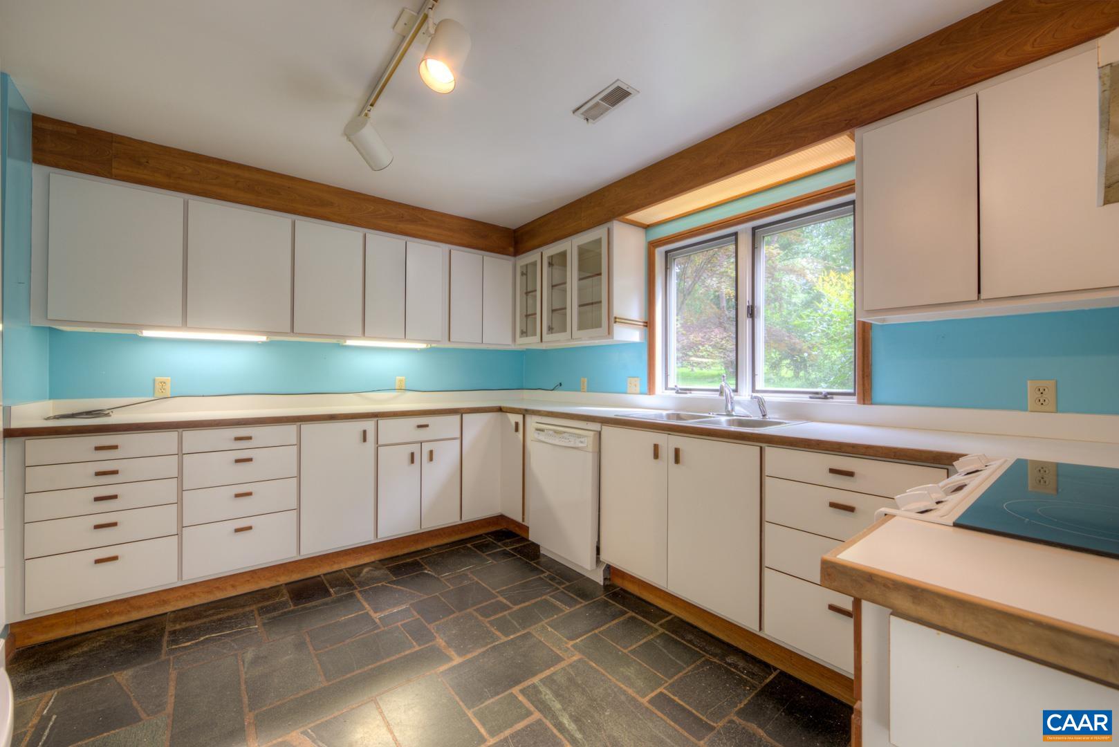 305 Cedar Bluff Road Charlottesville, VA 22901 - Photo 28 of 37 a kitchen with granite countertop white cabinets and sink