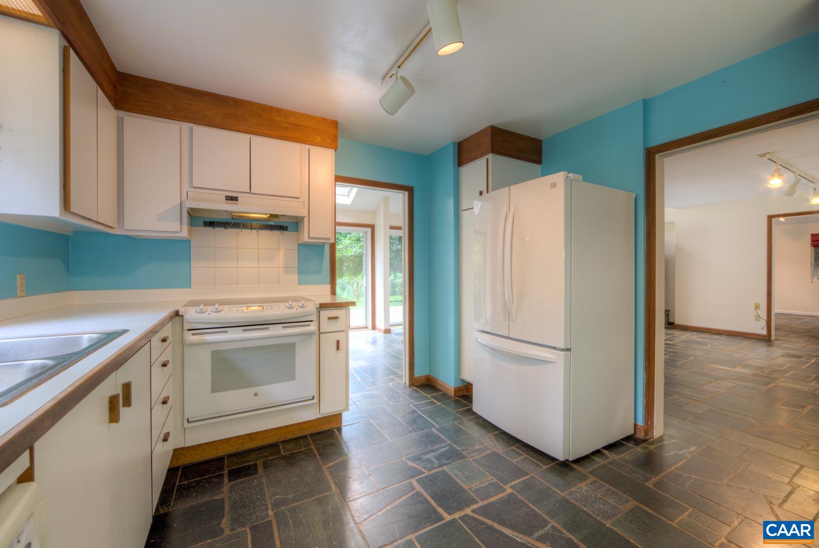 305 Cedar Bluff Road Charlottesville, VA 22901 - Photo 29 of 37 a kitchen with a refrigerator sink and cabinets