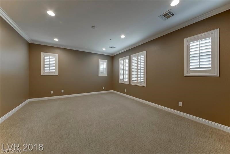 3144 Whitfeild Avenue Henderson, NV 89044 - Photo 19 of 55 Well-lit room featuring crisp crown molding and plantation shutters on multiple windows.