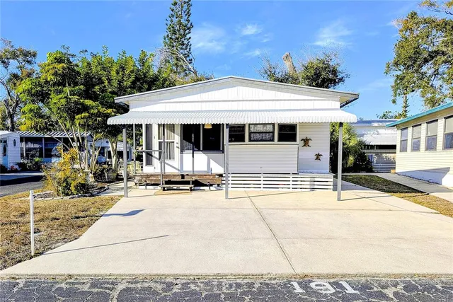 a backyard of a house with yard and outdoor seating