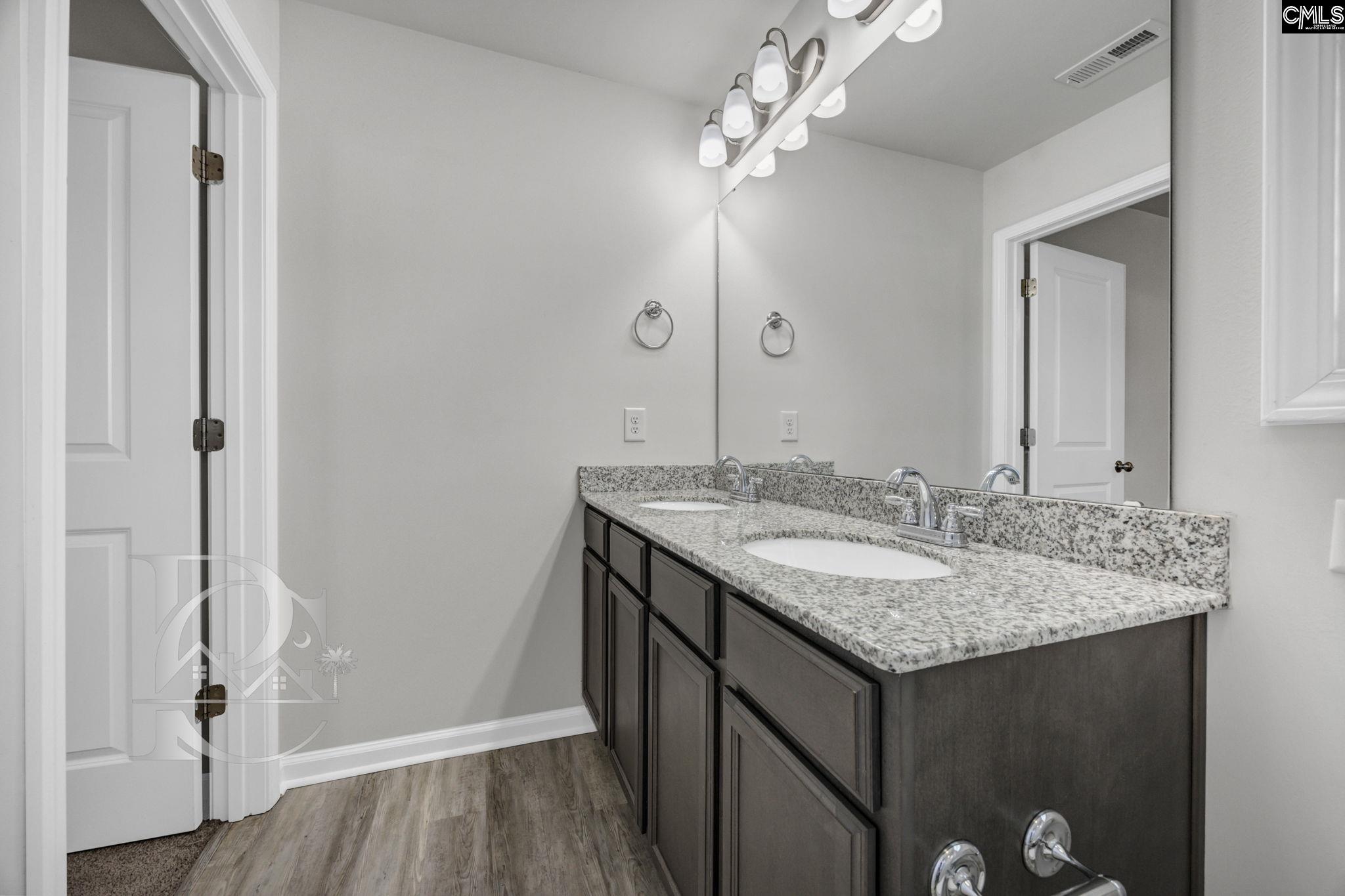 235 Drayton Hall Road West Columbia, SC 29172 - Photo 18 of 24 a bathroom with a granite countertop sink a mirror and shower