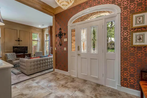 a living room with furniture fireplace and a large window
